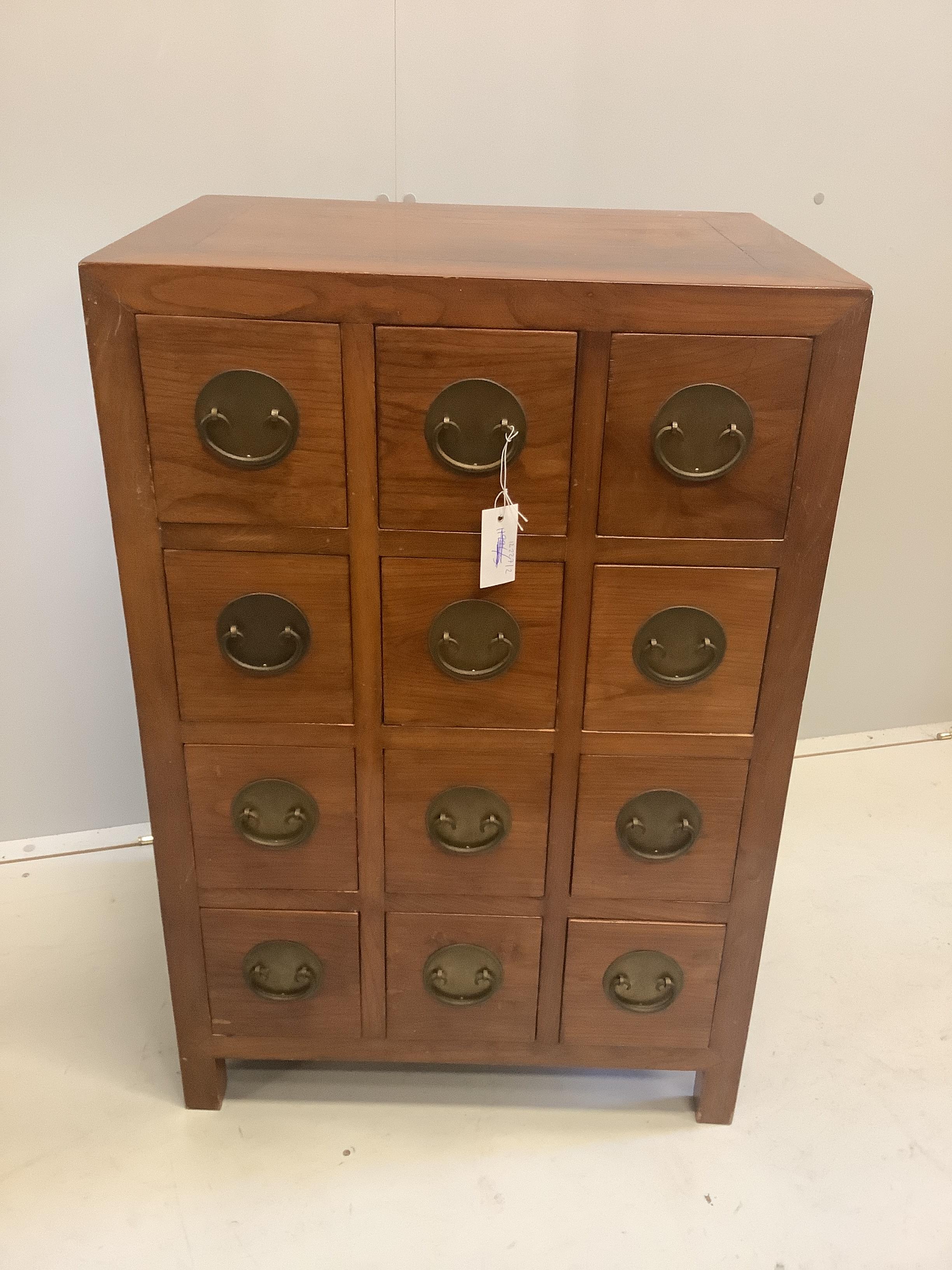 A Chinese elm chest of twelve drawers, width 61cm, depth 45cm, height 91cm